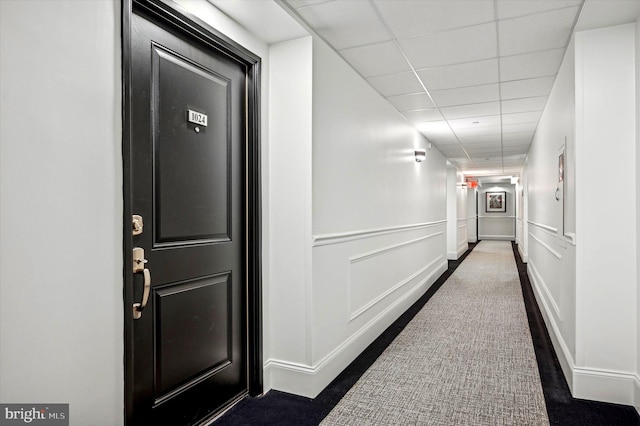 hallway featuring a paneled ceiling