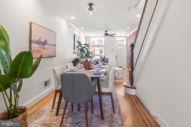 dining area featuring crown molding, ceiling fan, and light hardwood / wood-style floors