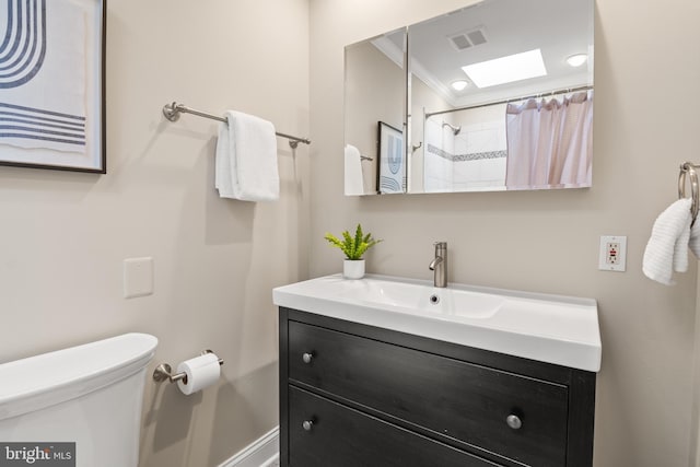 bathroom with vanity, toilet, and walk in shower