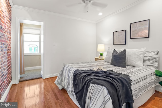 bedroom featuring hardwood / wood-style floors, ornamental molding, and ceiling fan