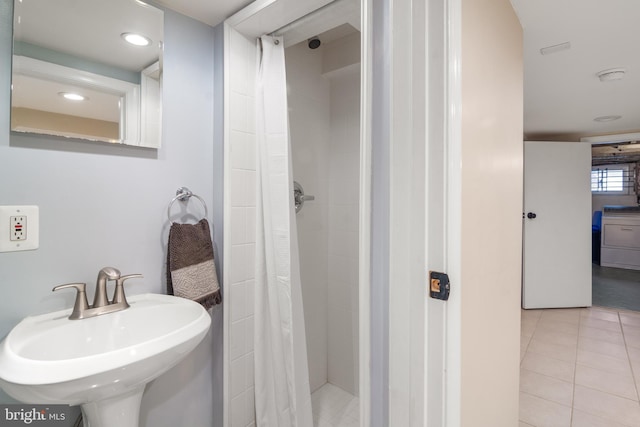 bathroom featuring tile patterned flooring, sink, and a shower with curtain