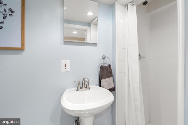 bathroom featuring sink and curtained shower