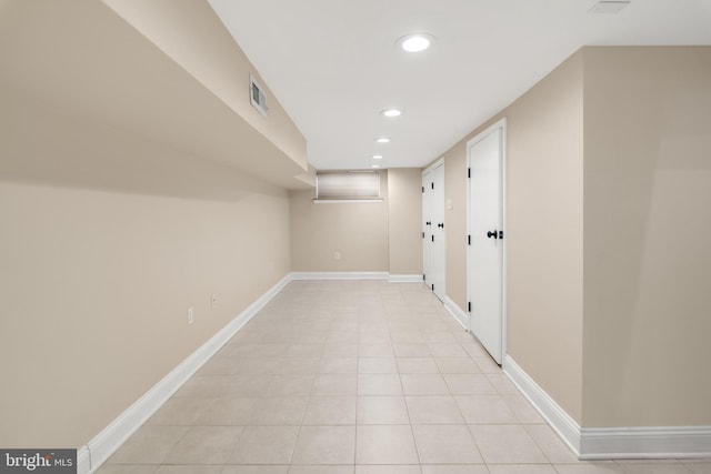 hall featuring light tile patterned floors