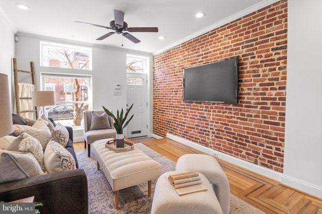 living room featuring crown molding, ceiling fan, and brick wall