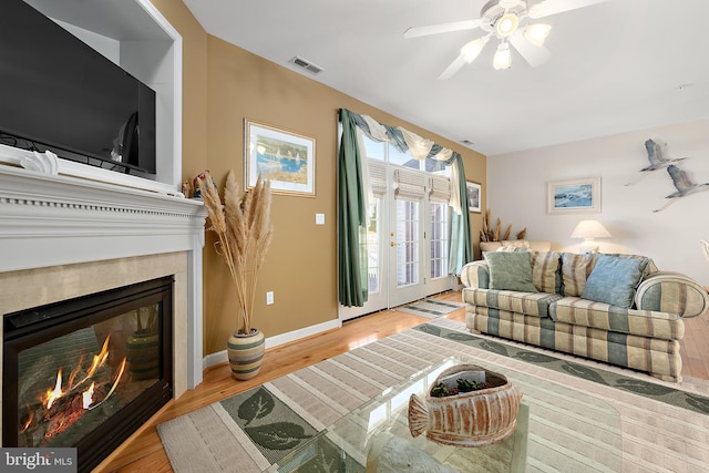 living room featuring ceiling fan and light wood-type flooring