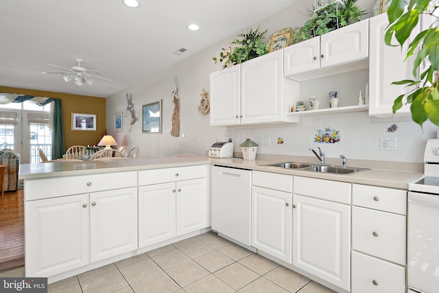 kitchen with sink, white appliances, ceiling fan, white cabinetry, and kitchen peninsula