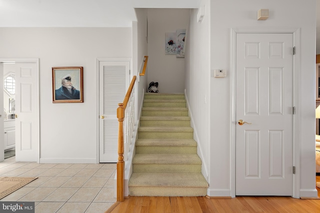 stairs with hardwood / wood-style flooring