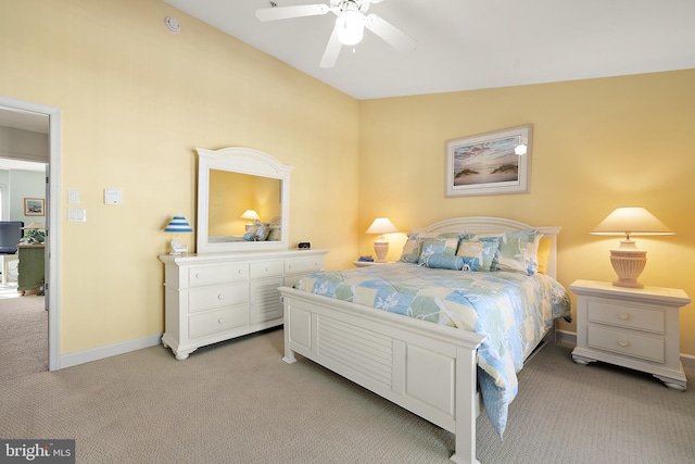 carpeted bedroom with ceiling fan and vaulted ceiling