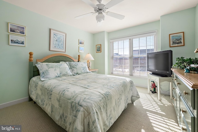 bedroom featuring light carpet and ceiling fan