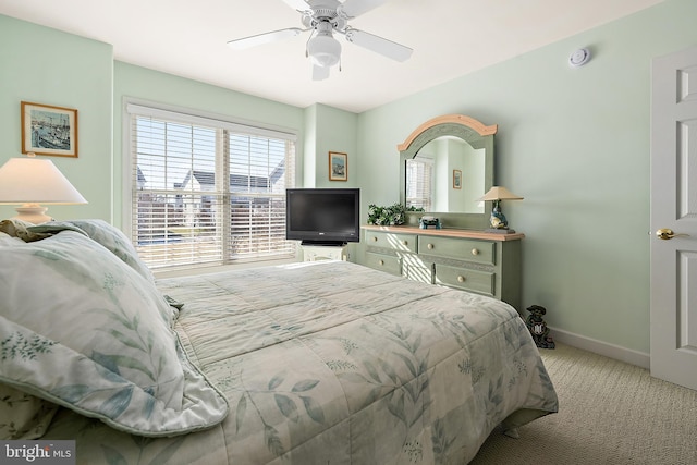 bedroom featuring light colored carpet and ceiling fan