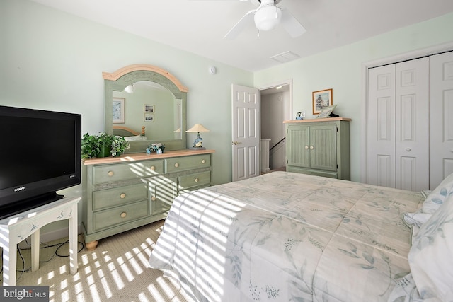 bedroom with ceiling fan and a closet