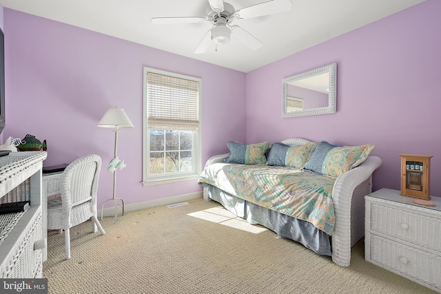 bedroom featuring light colored carpet and ceiling fan