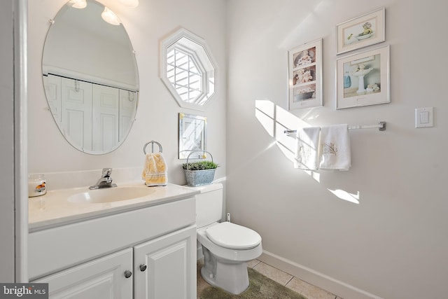 bathroom featuring vanity, toilet, and tile patterned flooring