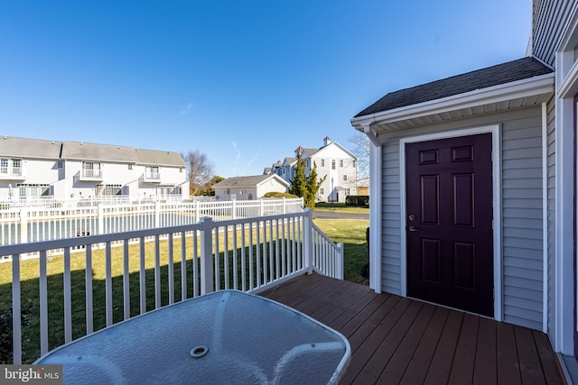 wooden deck featuring a yard