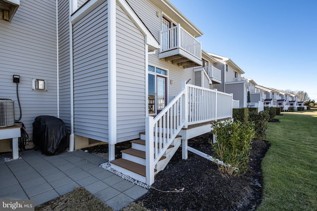 view of home's exterior featuring central AC unit, a lawn, and a patio