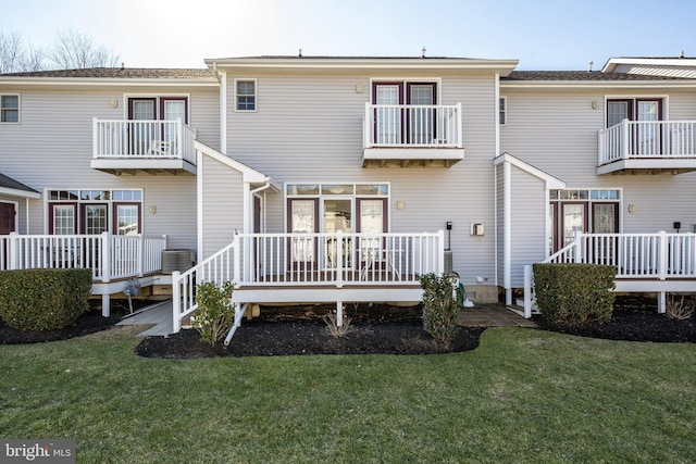 back of property featuring central AC, a yard, and a deck