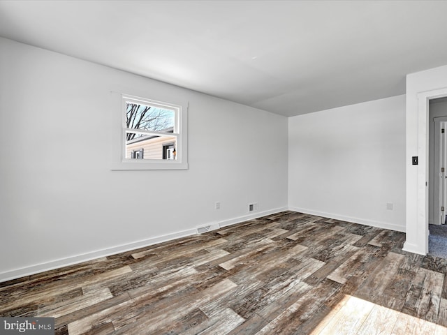 spare room featuring dark hardwood / wood-style flooring