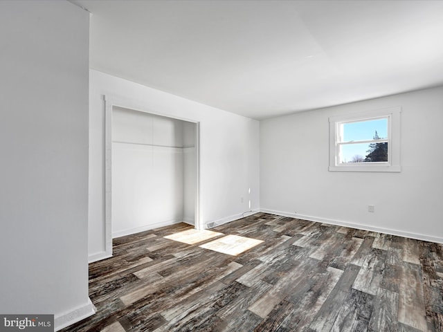 unfurnished bedroom with hardwood / wood-style floors and a closet