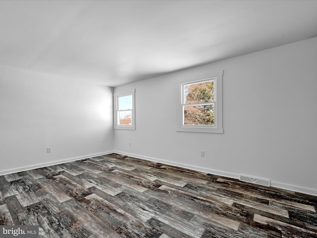 unfurnished room with wood-type flooring