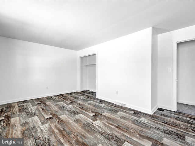 empty room featuring dark hardwood / wood-style flooring