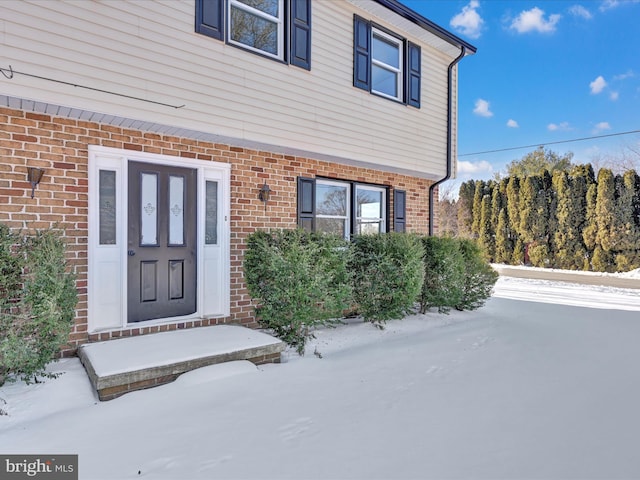 view of snow covered property entrance