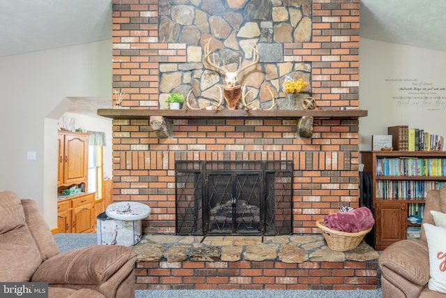 living room with a large fireplace and vaulted ceiling