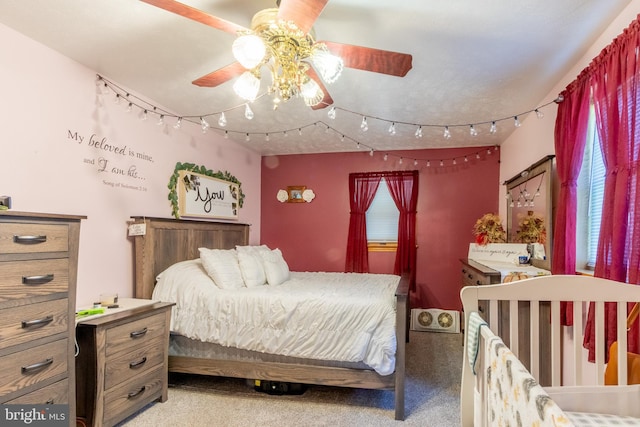 bedroom with rail lighting, carpet, and ceiling fan