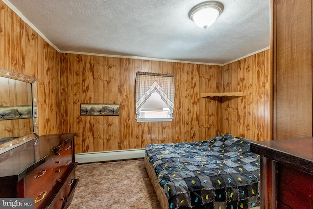 carpeted bedroom with ornamental molding, wood walls, a textured ceiling, and baseboard heating