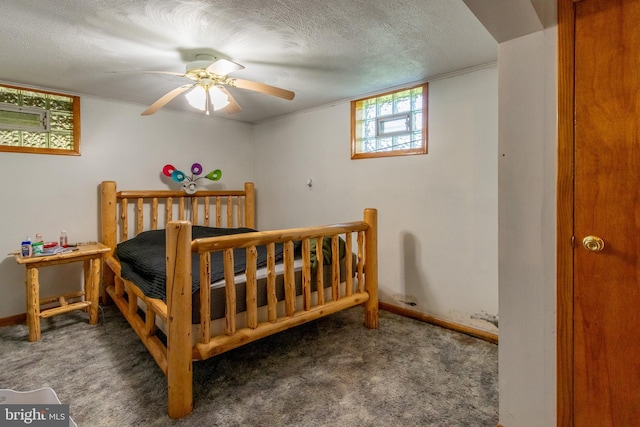 carpeted bedroom with ceiling fan and a textured ceiling