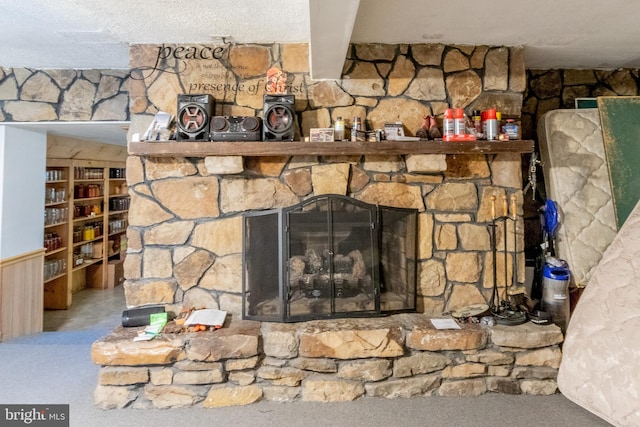 interior details with a stone fireplace and carpet