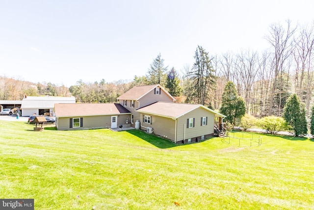 rear view of house featuring a yard