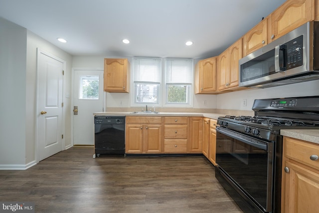 kitchen featuring dark hardwood / wood-style flooring, sink, black appliances, and light brown cabinets