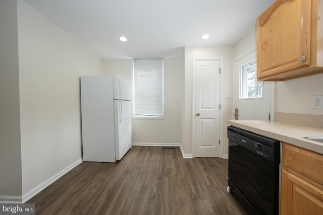 kitchen with dark hardwood / wood-style floors, dishwasher, white fridge, and light brown cabinetry