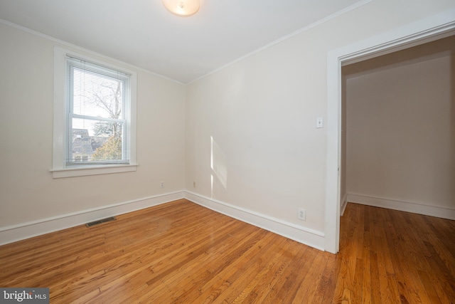 unfurnished room featuring crown molding and light hardwood / wood-style flooring