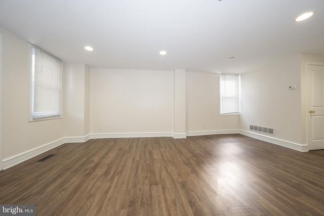 spare room with dark hardwood / wood-style flooring