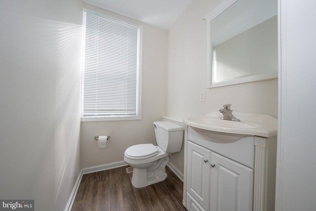 bathroom featuring vanity, toilet, and hardwood / wood-style floors