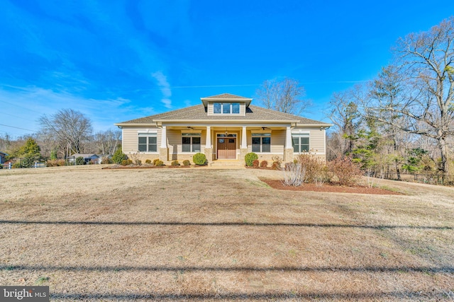 view of front of home with a porch and a front yard