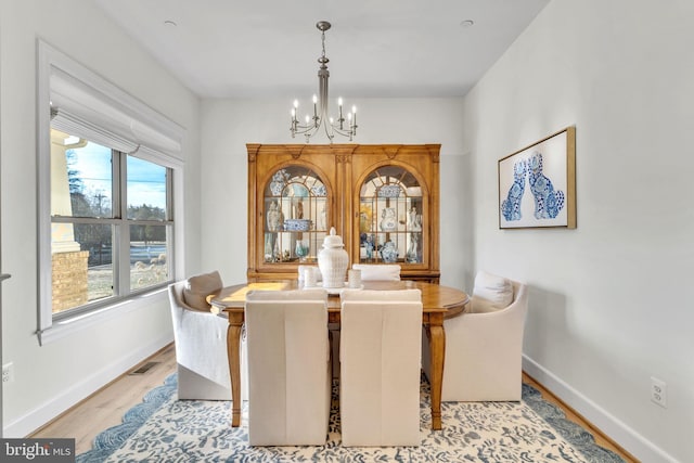 dining room featuring a chandelier and light wood-type flooring