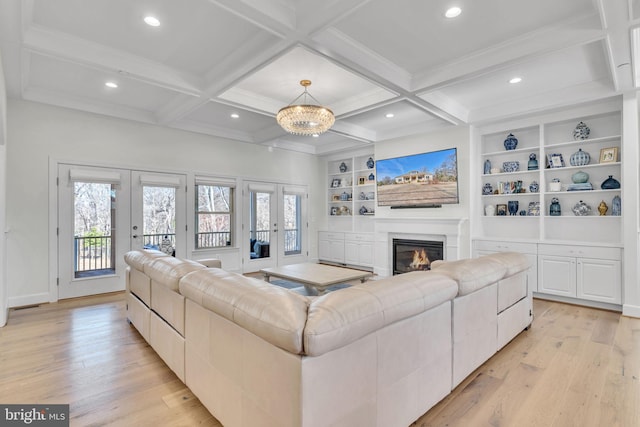 living room featuring coffered ceiling, beam ceiling, french doors, and light wood-type flooring