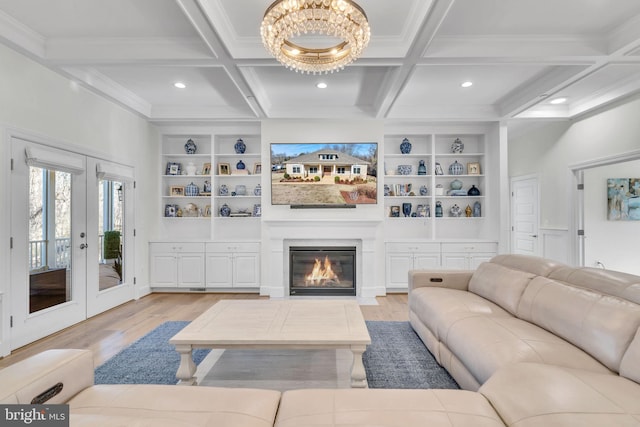 living room featuring beam ceiling, coffered ceiling, and light wood-type flooring