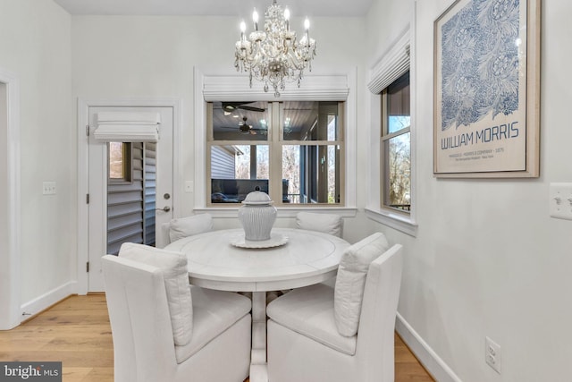 dining room featuring light hardwood / wood-style floors and a notable chandelier