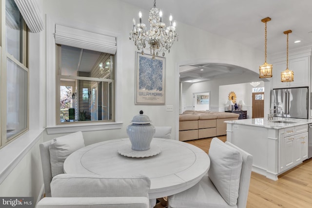 dining room with sink and light hardwood / wood-style flooring