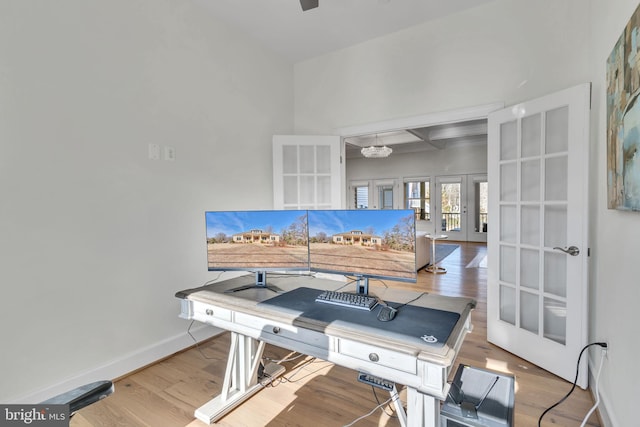 office area featuring coffered ceiling, hardwood / wood-style floors, french doors, and beamed ceiling