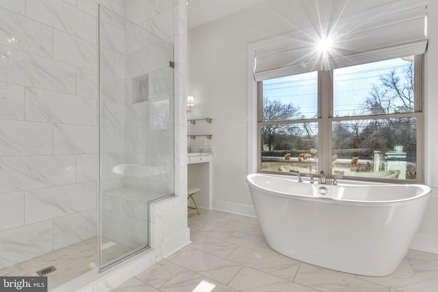 bathroom with a healthy amount of sunlight and independent shower and bath