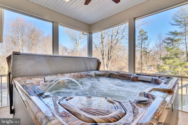 sunroom / solarium featuring a jacuzzi and plenty of natural light