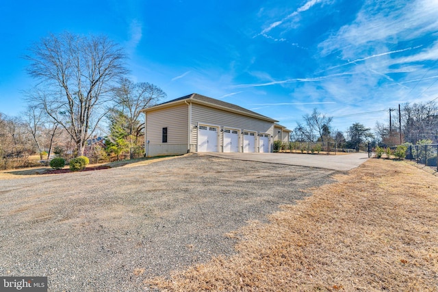 view of side of property featuring a garage and a yard