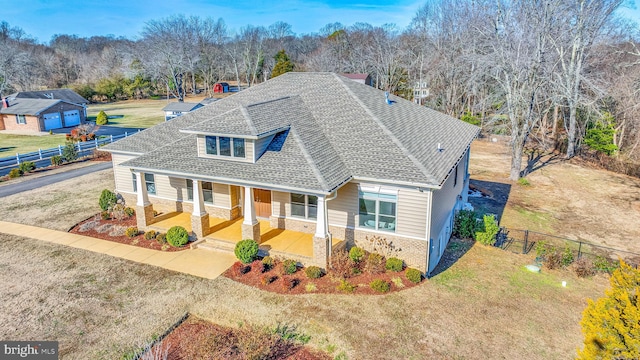 view of front of property featuring covered porch and a front lawn