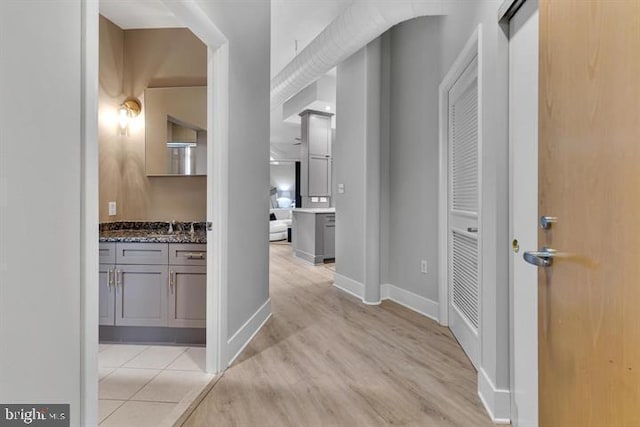 corridor with light hardwood / wood-style flooring