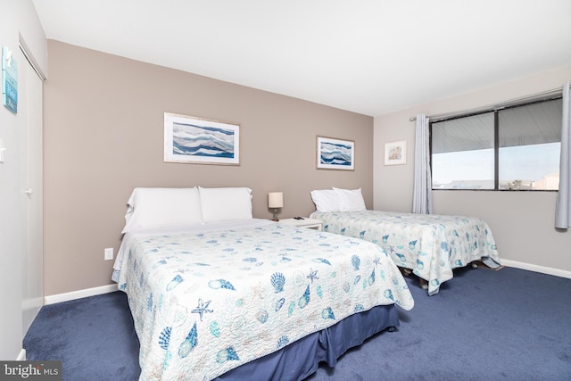 bedroom with dark colored carpet