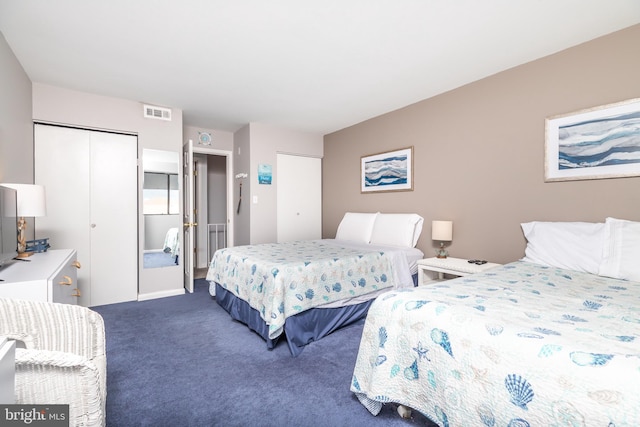 carpeted bedroom featuring multiple closets